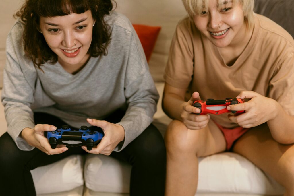 two people playing video games to show that turning participation into a game can improve web design for social change