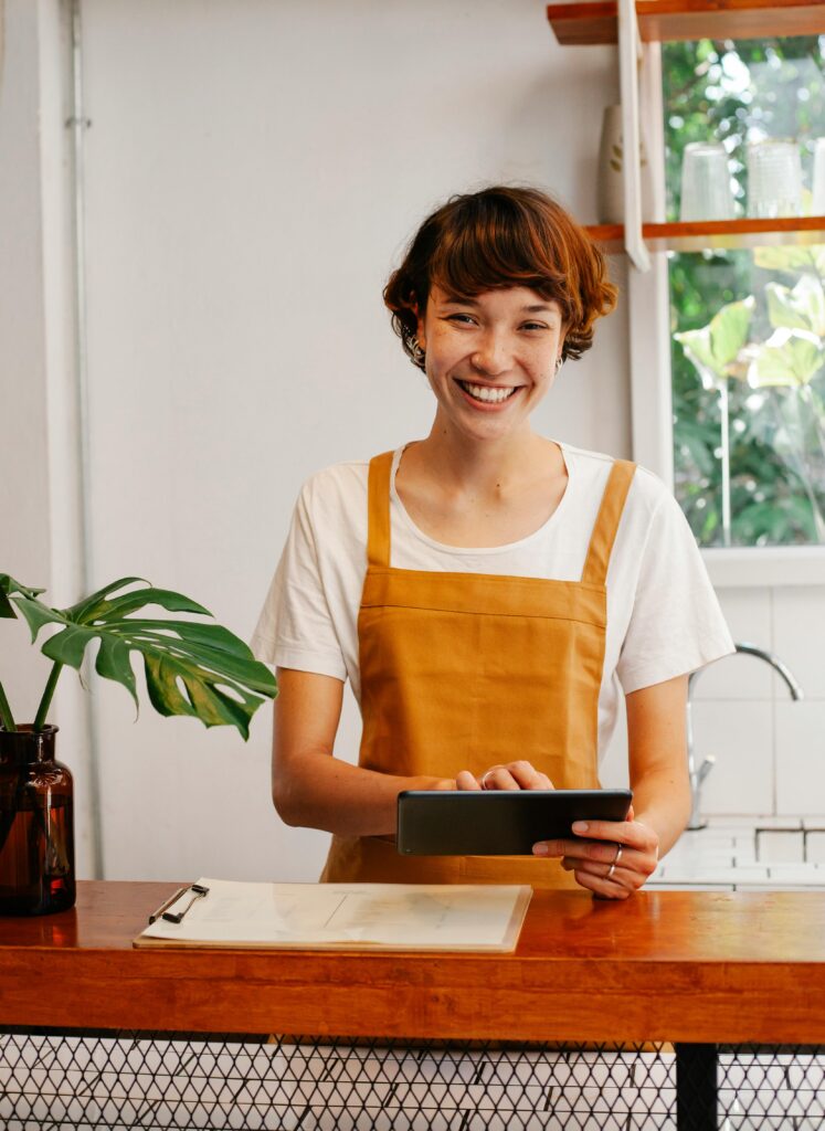 female business owner smiles at camera demonstrating the importance of website for small business